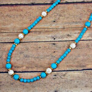 Turquoise and white stone bead necklace mixed with small gold beads.